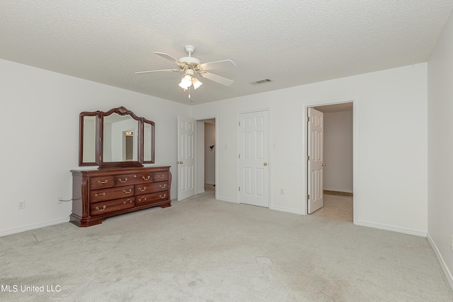 carpeted bedroom featuring a textured ceiling and ceiling fan