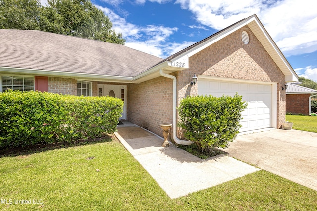 ranch-style house with a garage and a front lawn