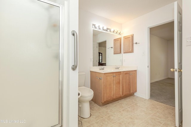 bathroom with vanity, toilet, and a shower with shower door