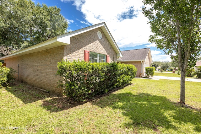 view of home's exterior with a lawn