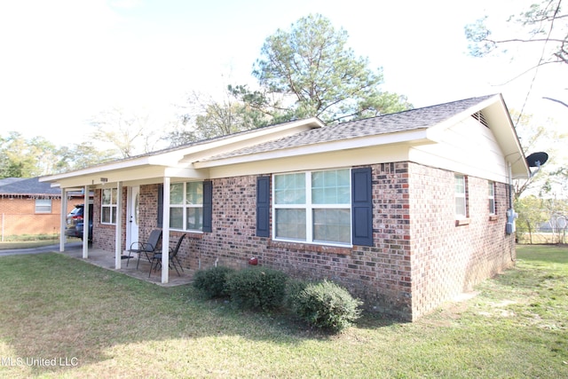 view of front of house with a front lawn and a patio