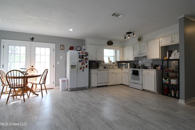 kitchen with white cabinets, french doors, white appliances, and a textured ceiling