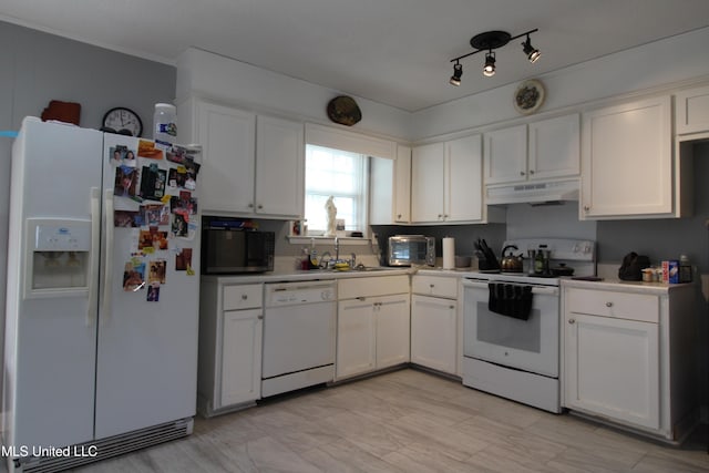 kitchen featuring sink, white appliances, and white cabinetry