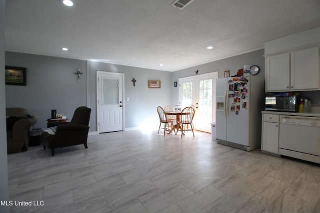 kitchen featuring white cabinets, french doors, and white appliances