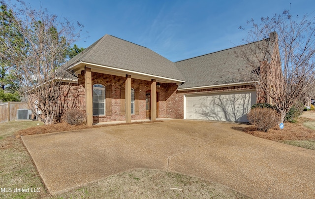 view of front of property with a garage and central air condition unit