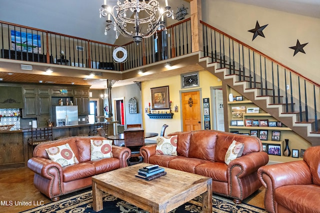 living area with stairs, a high ceiling, and a notable chandelier