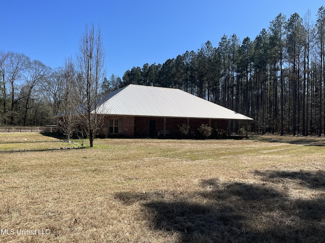 view of side of property with a yard