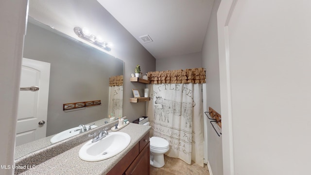 bathroom with toilet, walk in shower, and vanity