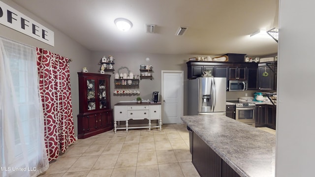 kitchen featuring appliances with stainless steel finishes and light tile patterned floors