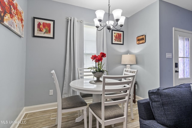 15035 Baylor Ave, Gulfport, MS 39503 - dining space with healthy amount of natural light, a chandelier, wood finished floors, and baseboards
