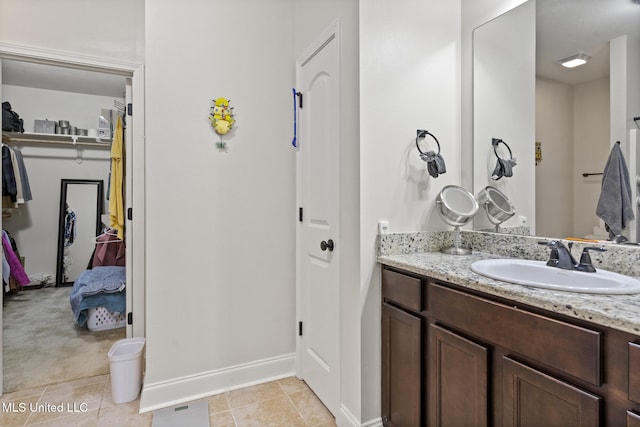 15035 Baylor Ave, Gulfport, MS 39503 - bathroom with vanity, baseboards, a closet, and tile patterned flooring