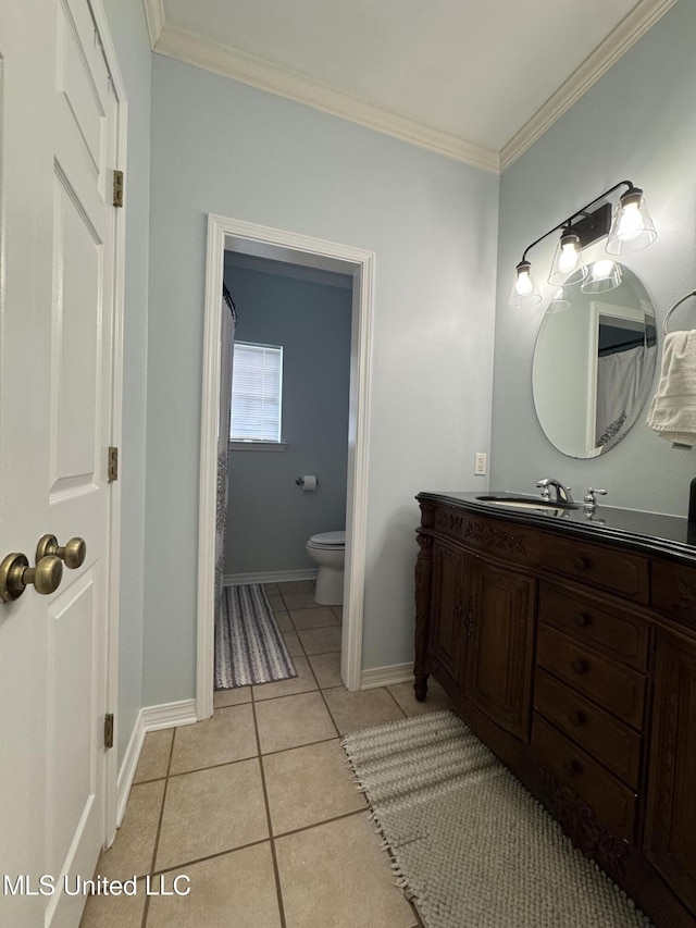 bathroom featuring toilet, ornamental molding, vanity, tile patterned flooring, and baseboards