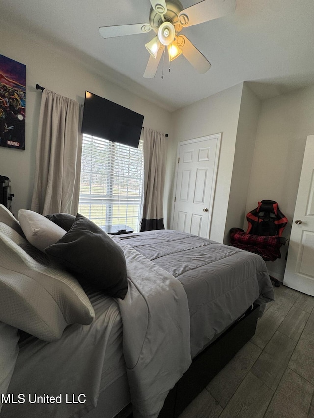 bedroom with wood finished floors and a ceiling fan