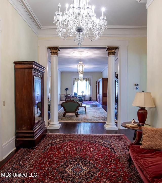 corridor with crown molding, dark hardwood / wood-style floors, decorative columns, and a chandelier