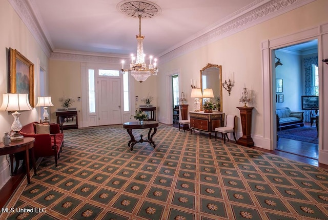 foyer with a notable chandelier and crown molding