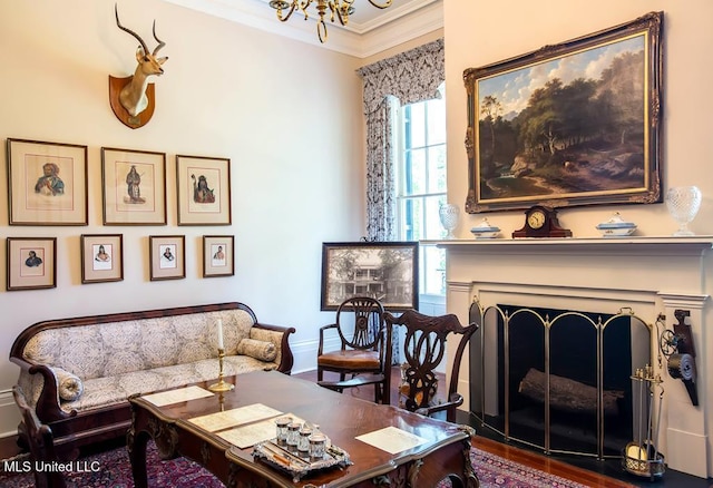 living room with ornamental molding, a notable chandelier, and hardwood / wood-style floors