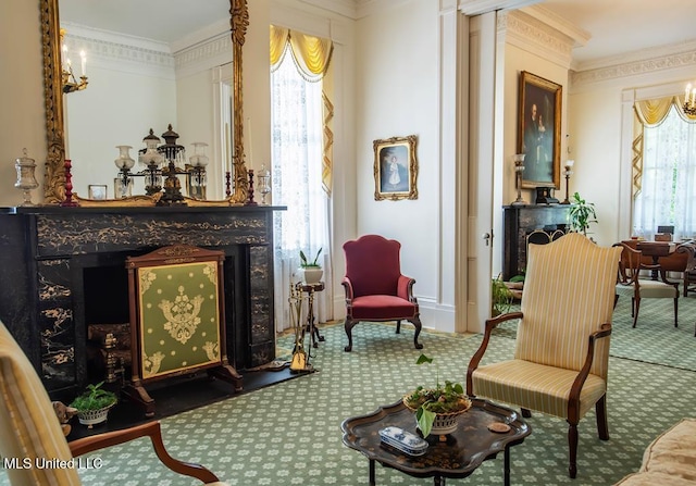 sitting room featuring carpet floors and crown molding