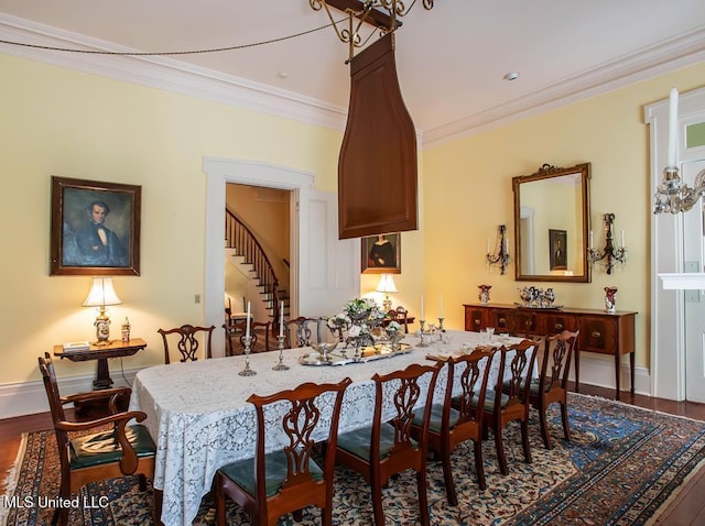 dining area featuring ornamental molding and hardwood / wood-style flooring