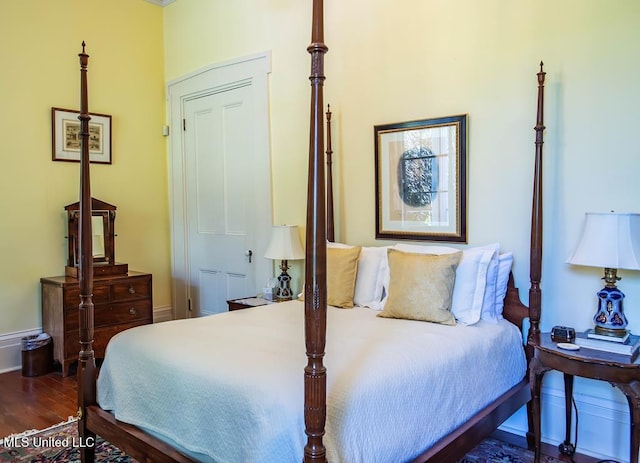 bedroom with dark hardwood / wood-style flooring