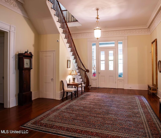 foyer featuring ornamental molding and dark hardwood / wood-style floors