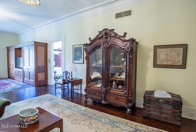 living room featuring ornamental molding and dark hardwood / wood-style flooring