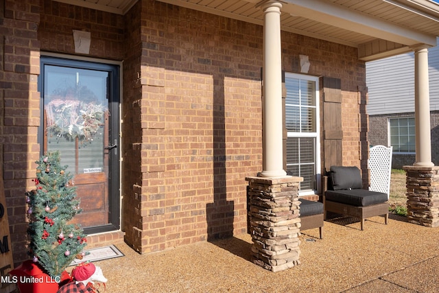 view of exterior entry with covered porch