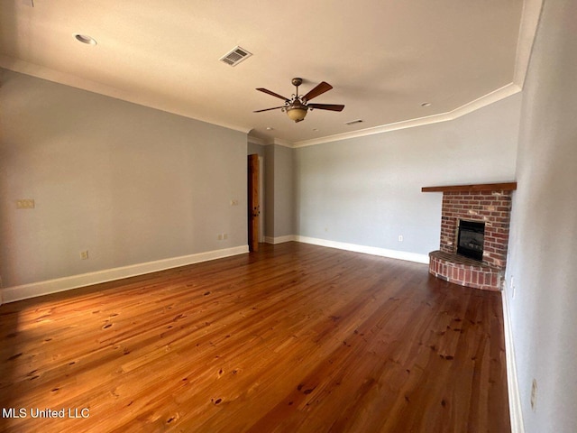 162 Lake Ridge Dr, Madison, MS 39110 - unfurnished living room with a ceiling fan, crown molding, hardwood / wood-style flooring, a brick fireplace, and baseboards