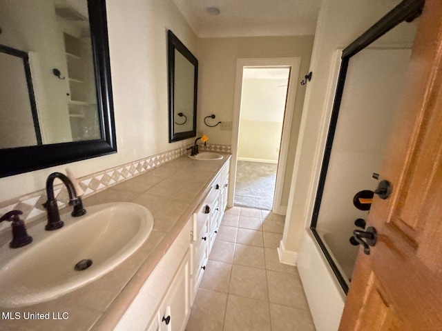 162 Lake Ridge Dr, Madison, MS 39110 - bathroom featuring tile patterned floors, double vanity, shower / bath combination with glass door, and baseboards