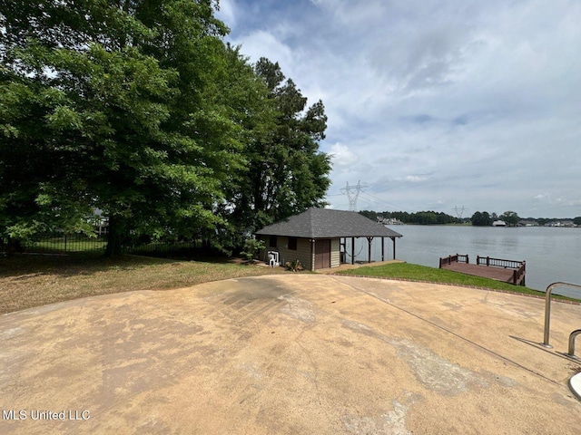 162 Lake Ridge Dr, Madison, MS 39110 - view of patio / terrace with fence, a boat dock, an outdoor structure, and a water view