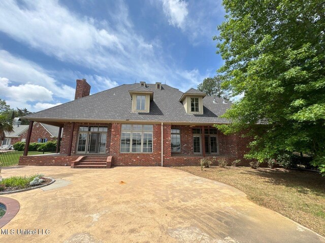 162 Lake Ridge Dr, Madison, MS 39110 - back of property featuring brick siding, fence, a chimney, and a patio area