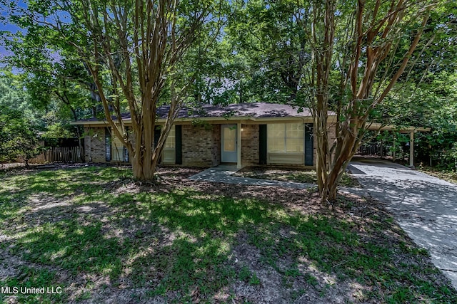 3217 N 2nd St, Ocean Springs, MS 39564 - view of front of property with brick siding, fence, driveway, and an attached carport