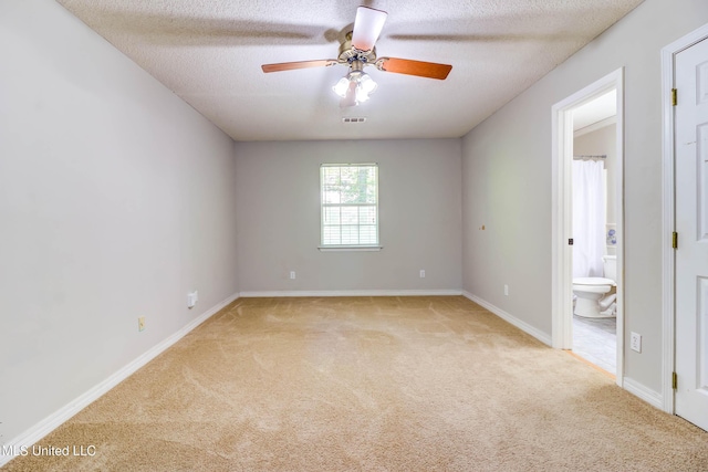 3217 N 2nd St, Ocean Springs, MS 39564 - spare room with light colored carpet, a ceiling fan, a textured ceiling, and baseboards