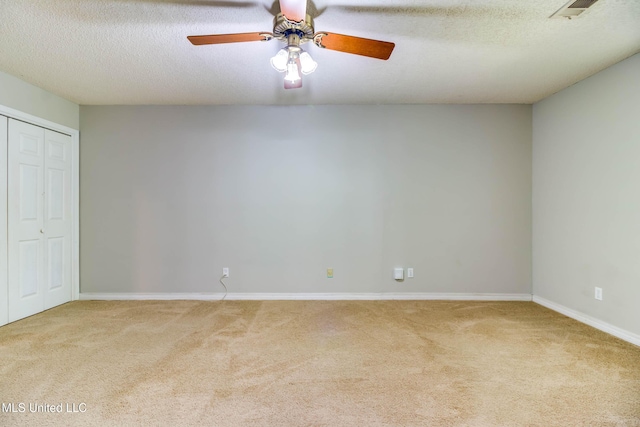 3217 N 2nd St, Ocean Springs, MS 39564 - unfurnished bedroom featuring carpet floors, baseboards, a closet, ceiling fan, and a textured ceiling