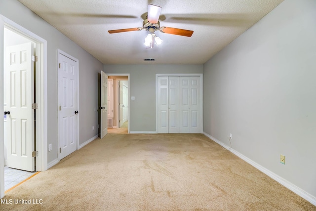 3217 N 2nd St, Ocean Springs, MS 39564 - unfurnished bedroom with carpet flooring, multiple closets, and baseboards