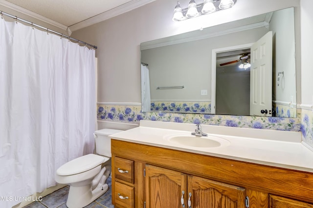 3217 N 2nd St, Ocean Springs, MS 39564 - full bathroom with crown molding, vanity, toilet, tile patterned flooring, and ceiling fan