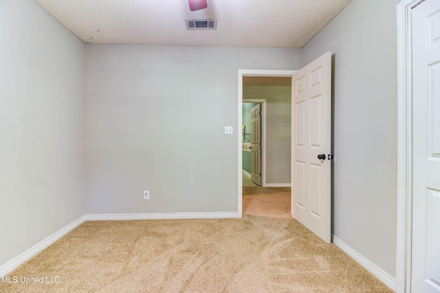 3217 N 2nd St, Ocean Springs, MS 39564 - unfurnished room featuring carpet, baseboards, and a textured ceiling