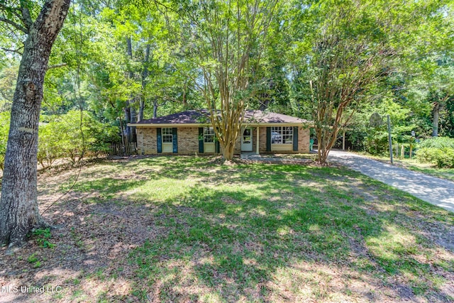 3217 N 2nd St, Ocean Springs, MS 39564 - view of front of house featuring brick siding, a front lawn, and driveway