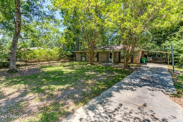 3217 N 2nd St, Ocean Springs, MS 39564 - view of front of property featuring brick siding, driveway, a front yard, and covered porch