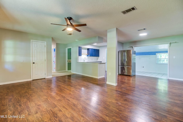 3217 N 2nd St, Ocean Springs, MS 39564 - unfurnished living room with ceiling fan, a sink, a textured ceiling, dark wood-type flooring, and baseboards