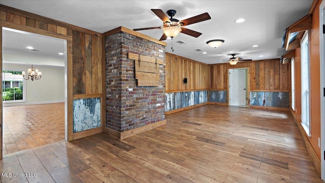 112 Eastgate Cir, Forest, MS 39074 - unfurnished living room featuring a ceiling fan, wooden walls, a chandelier, wood finished floors, and recessed lighting
