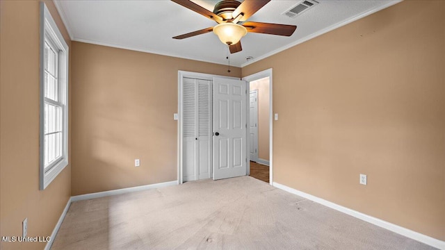 112 Eastgate Cir, Forest, MS 39074 - unfurnished bedroom with a closet, ornamental molding, carpet, multiple windows, and a ceiling fan