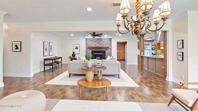 112 Eastgate Cir, Forest, MS 39074 - living room with a ceiling fan, a fireplace, wood finished floors, ornamental molding, and recessed lighting
