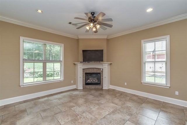 unfurnished living room featuring ornamental molding, a glass covered fireplace, and baseboards