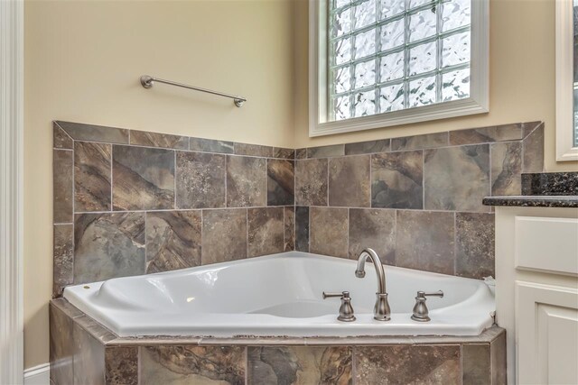 bathroom featuring a bath and vanity