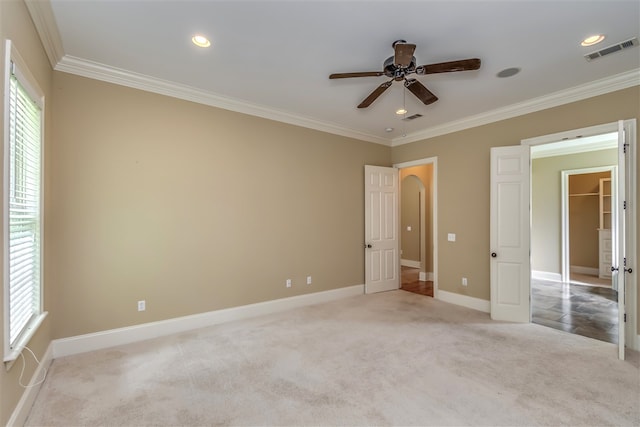 unfurnished bedroom featuring recessed lighting, visible vents, ornamental molding, carpet flooring, and baseboards