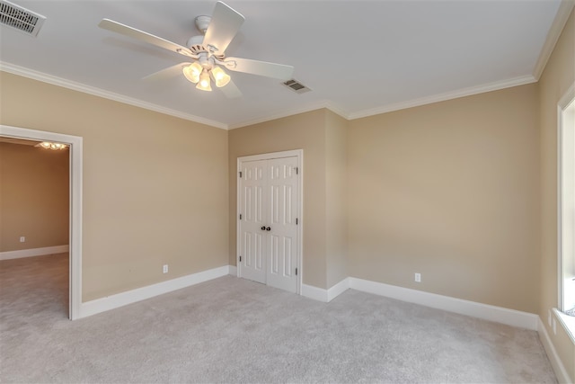 empty room with ornamental molding, visible vents, and baseboards