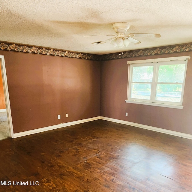 unfurnished room featuring a textured ceiling, dark hardwood / wood-style flooring, and ceiling fan