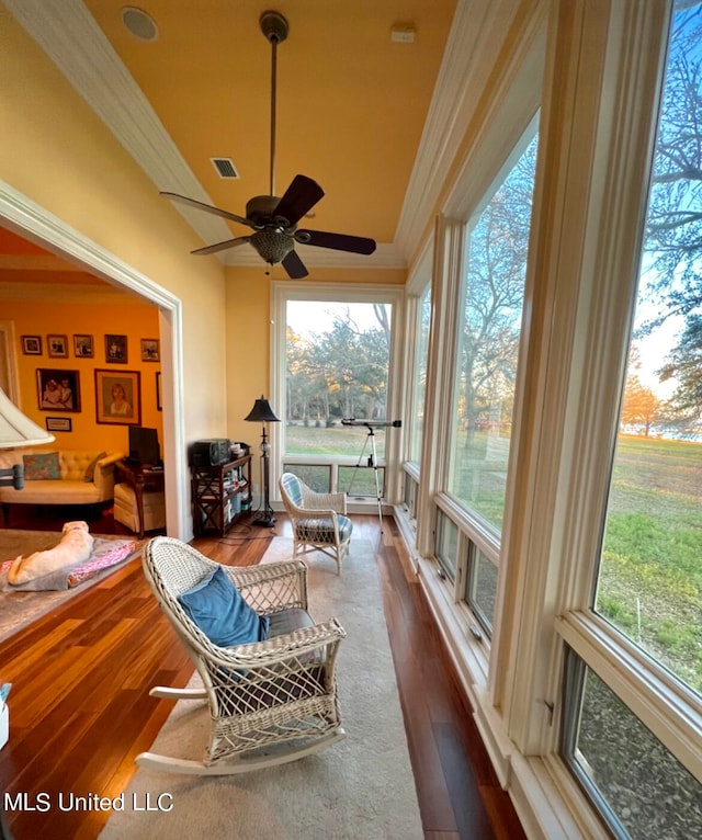 sunroom featuring ceiling fan