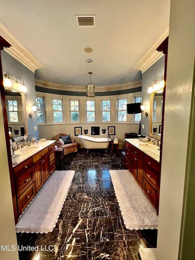 bathroom with vanity, a washtub, and crown molding