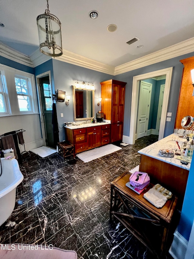 bathroom featuring ornamental molding, vanity, and a bathtub